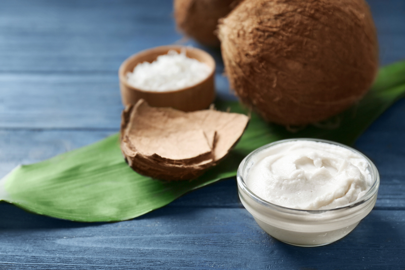 Coconut cream in bowl on blue background