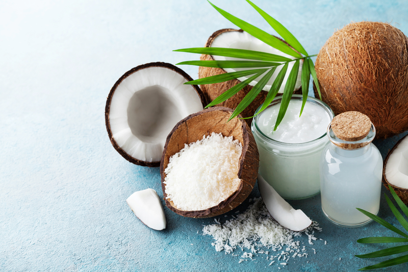 Organic coconut products for spa, cosmetic or food ingredients decorated palm leaves. Natural oil, water and shavings.